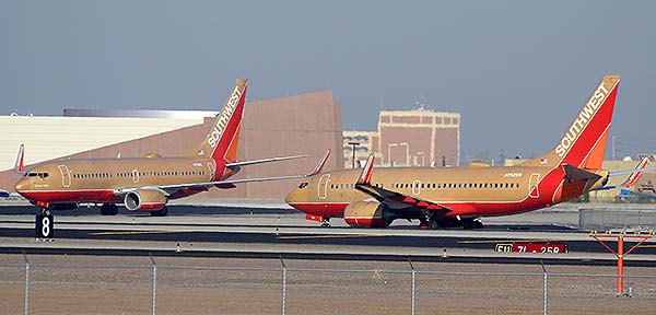 Southwest Boeing 737-7H4s N711HK and N792SW Retro Gold, Phoenix Sky Harbor, December 22, 2014